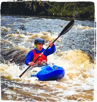 Archie in a Canoe on a white water river