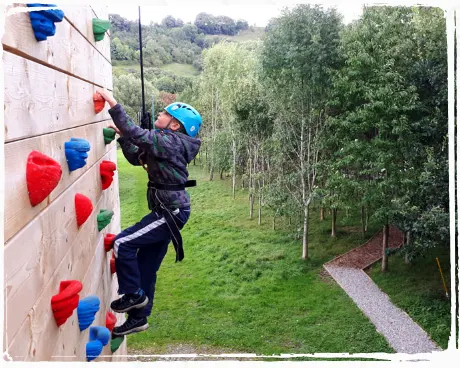 person climbing a rock wall